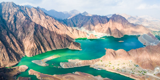 Scenic lake surrounded by majestic mountains from above