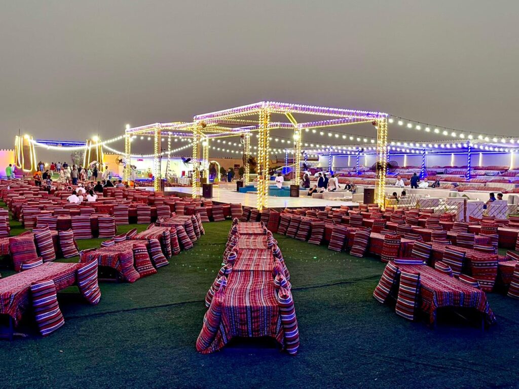 Traditional Bedouin camp set up in the desert with tents and outdoor seating