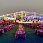 Traditional Bedouin camp set up in the desert with tents and outdoor seating