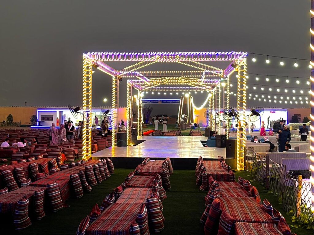 Bedouin camp in the desert with traditional tents and outdoor seating arrangements